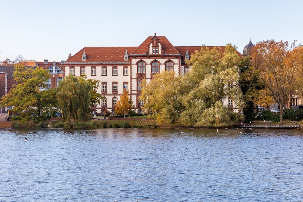 a large building sitting on the side of a lake