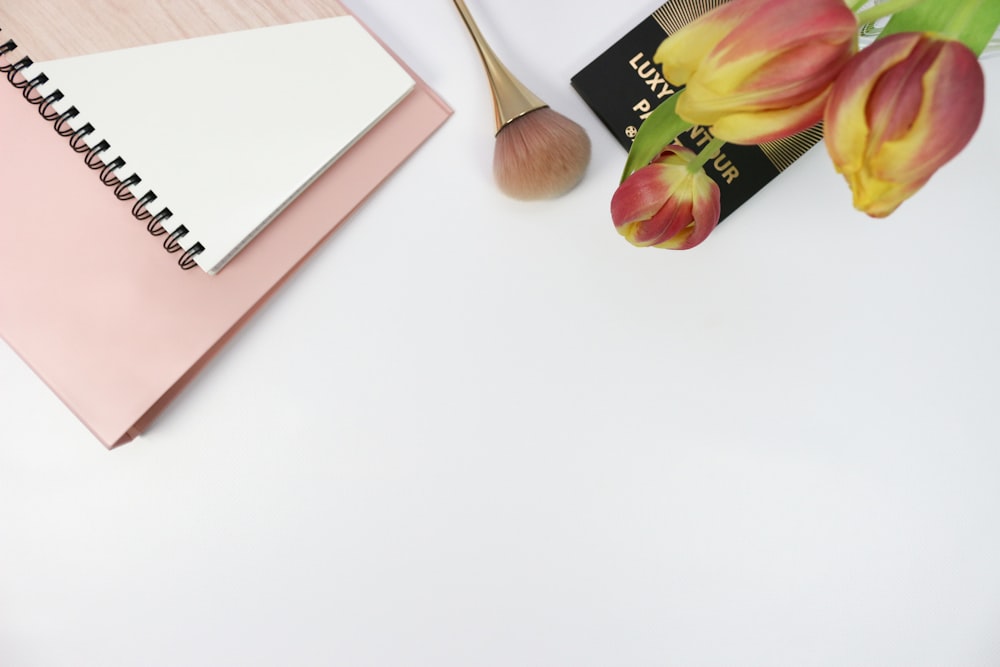 a notebook and a brush on a table