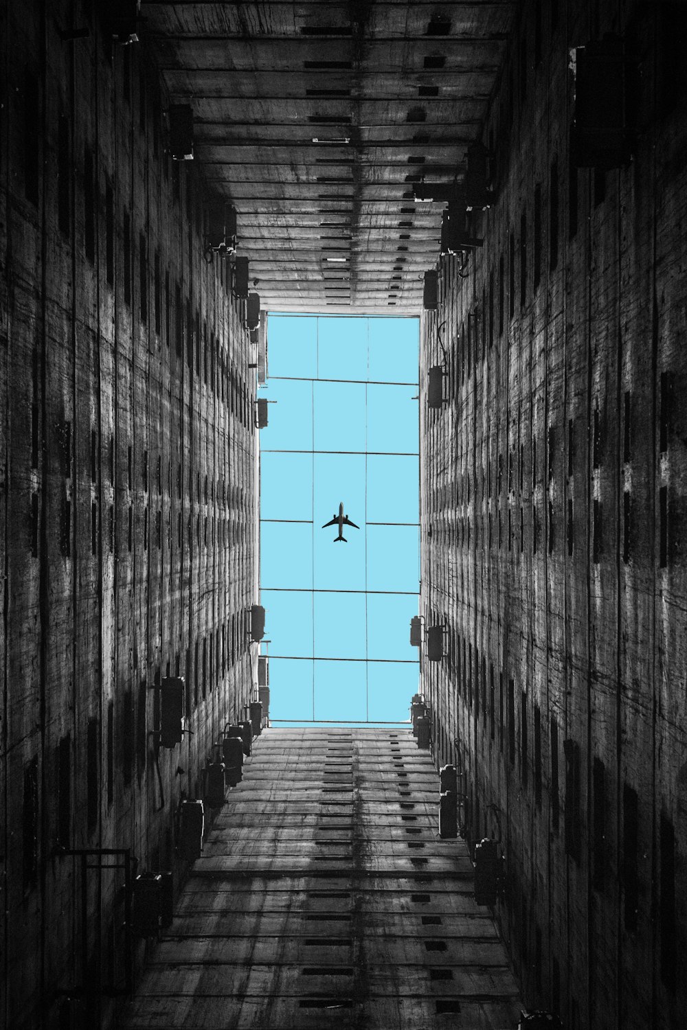 an airplane flying through a very tall building