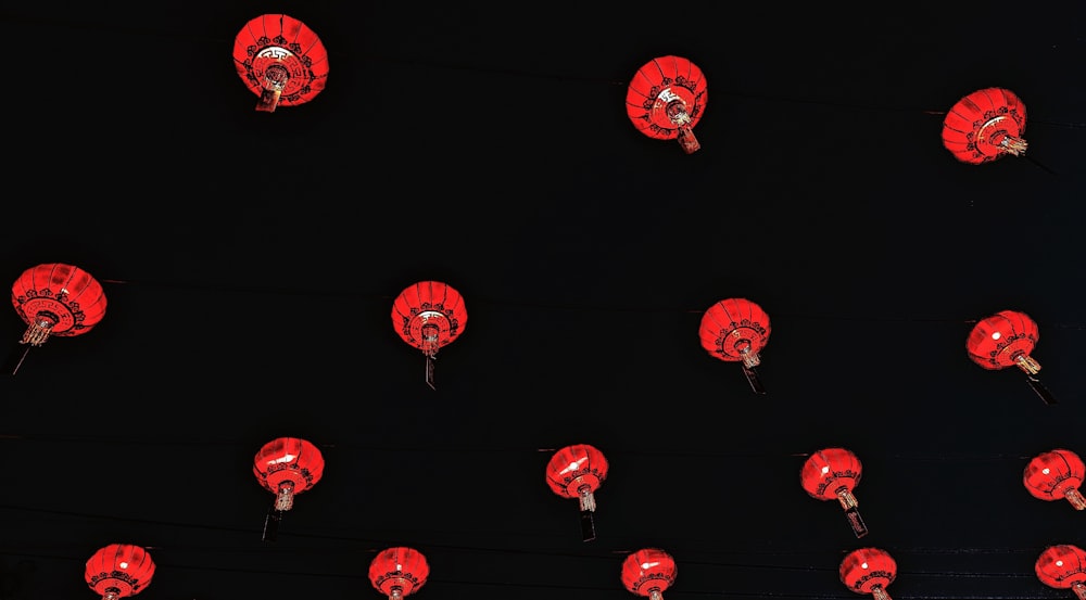 a group of red lanterns hanging from a wire