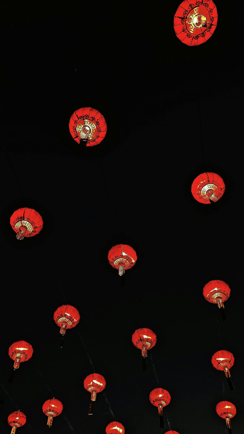 a group of red lanterns hanging from the ceiling