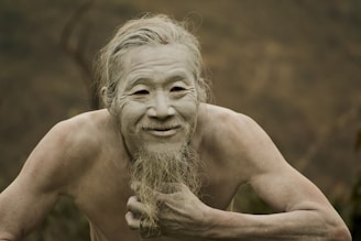 a man with a long beard and no shirt on