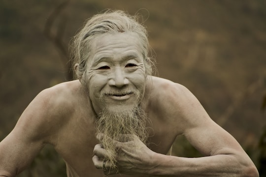 a man with a long beard and no shirt on