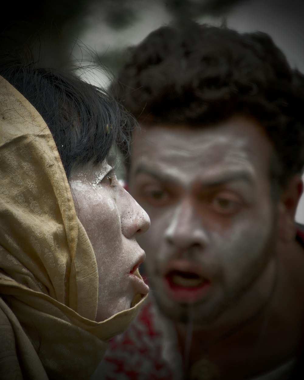 a man and a woman with white paint on their faces
