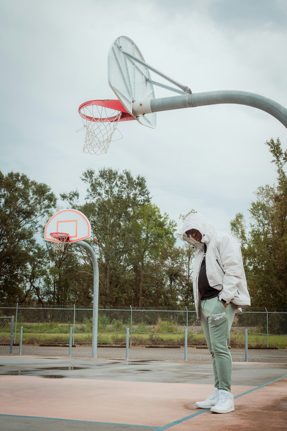 a man standing in front of a basketball hoop
