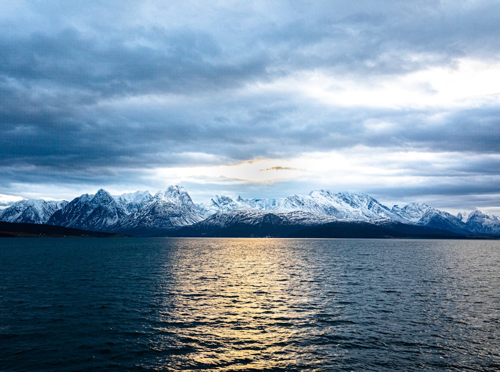 a large body of water with mountains in the background