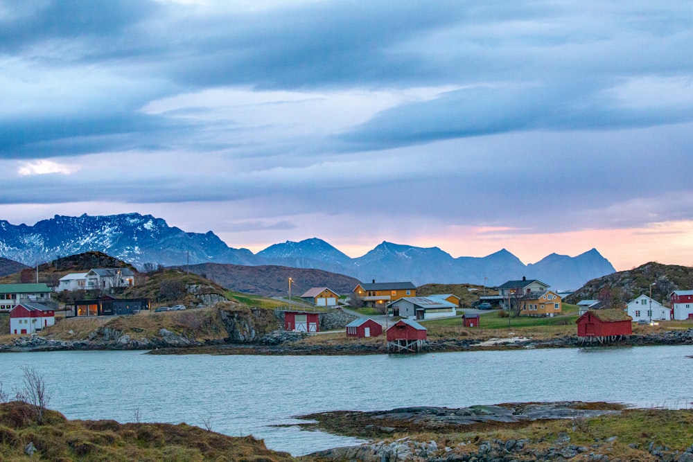 a body of water surrounded by mountains and houses