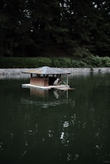 a small boat floating on top of a lake