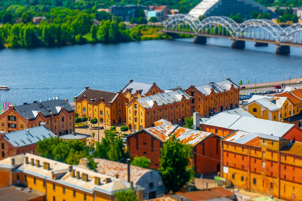 an aerial view of a city with a bridge in the background