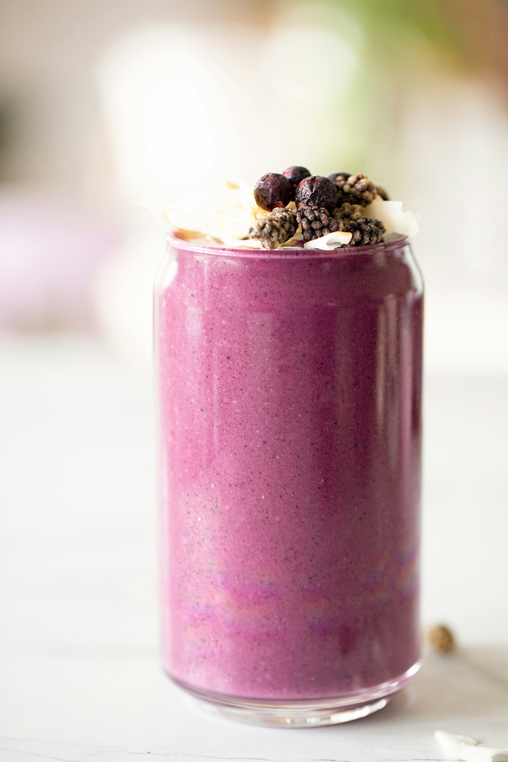 a purple smoothie in a glass with a spoon