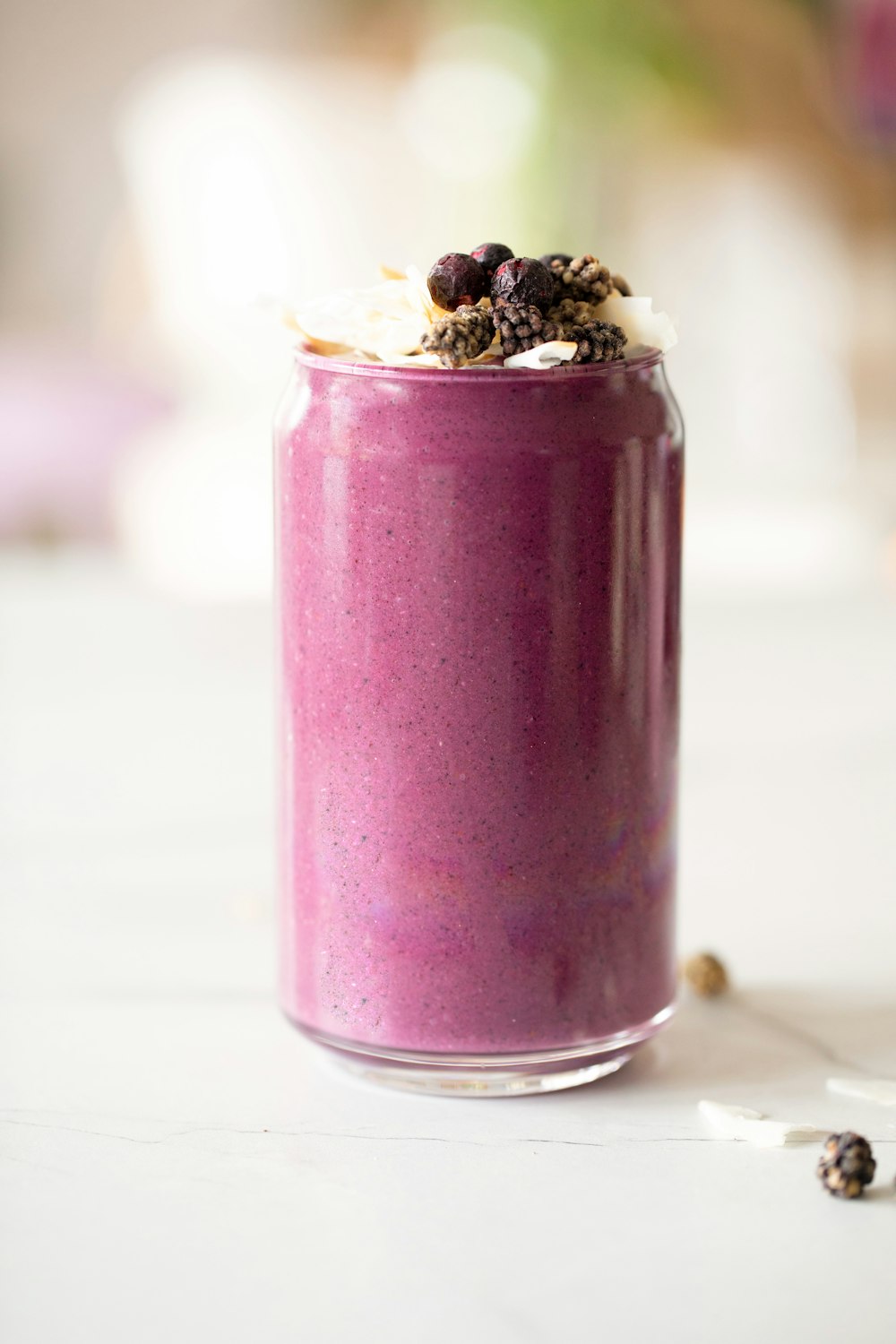 a purple smoothie in a glass with a spoon
