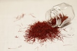 a glass jar filled with red stuff on top of a table