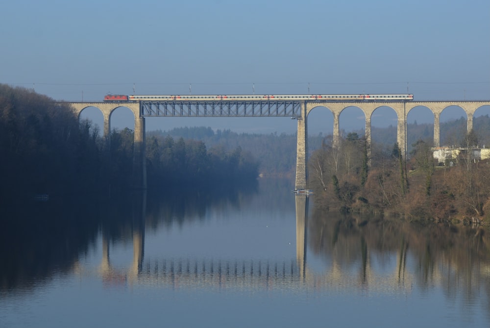 a train crossing a bridge over a body of water