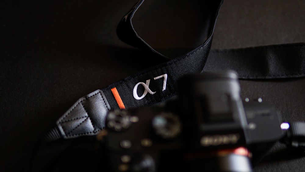 a camera and a camera strap on a table