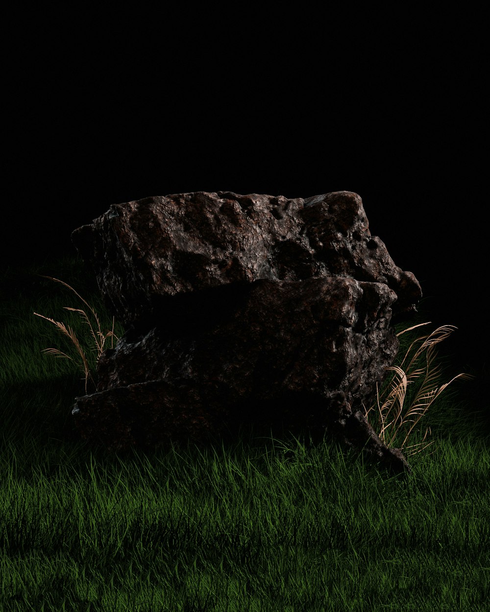 a large rock sitting on top of a lush green field