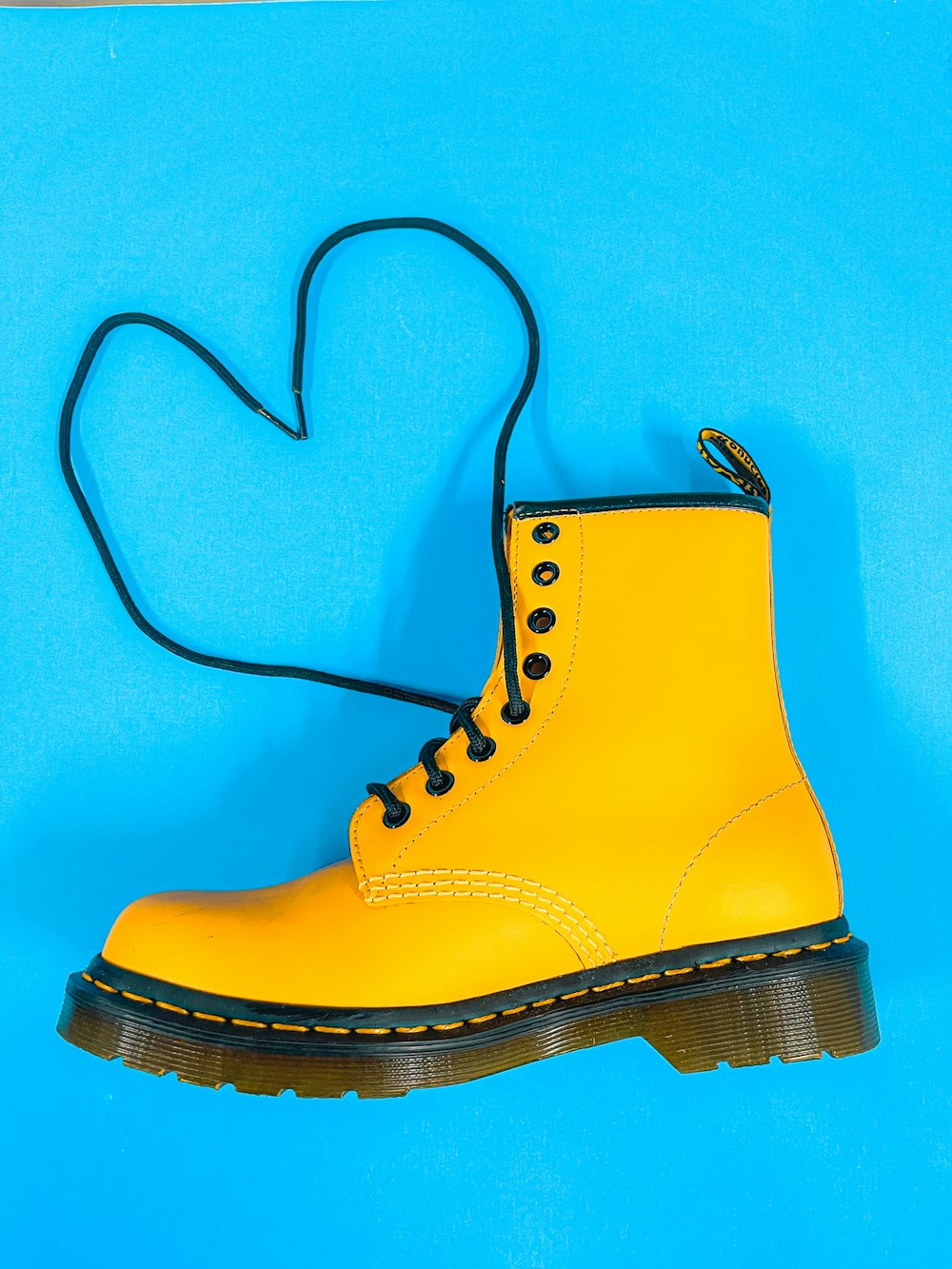 a pair of yellow boots on a blue background