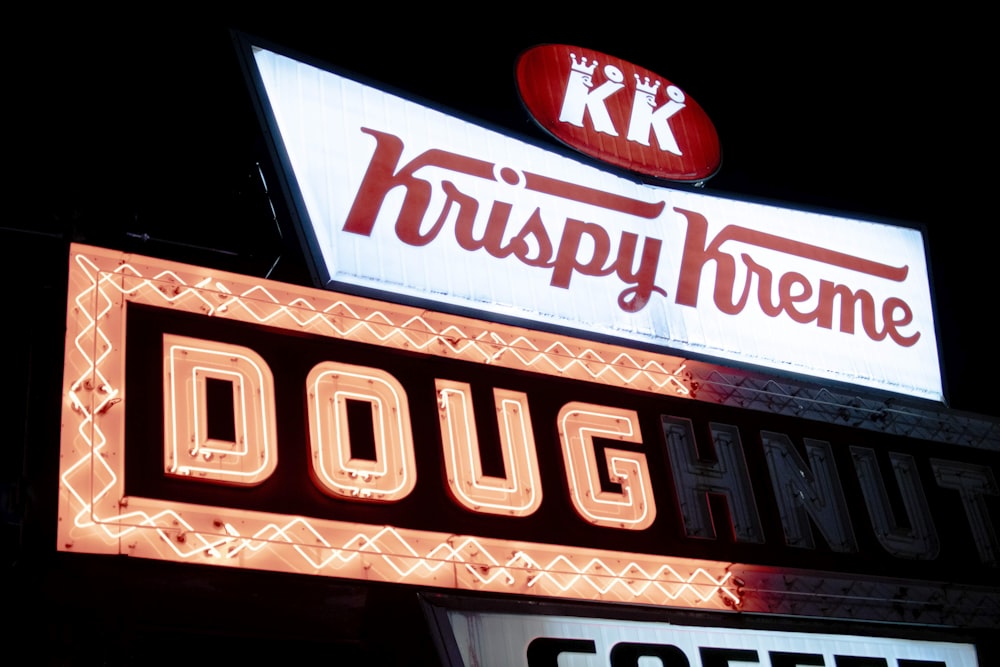 a neon sign for krispy kreme doughnuts and coffee