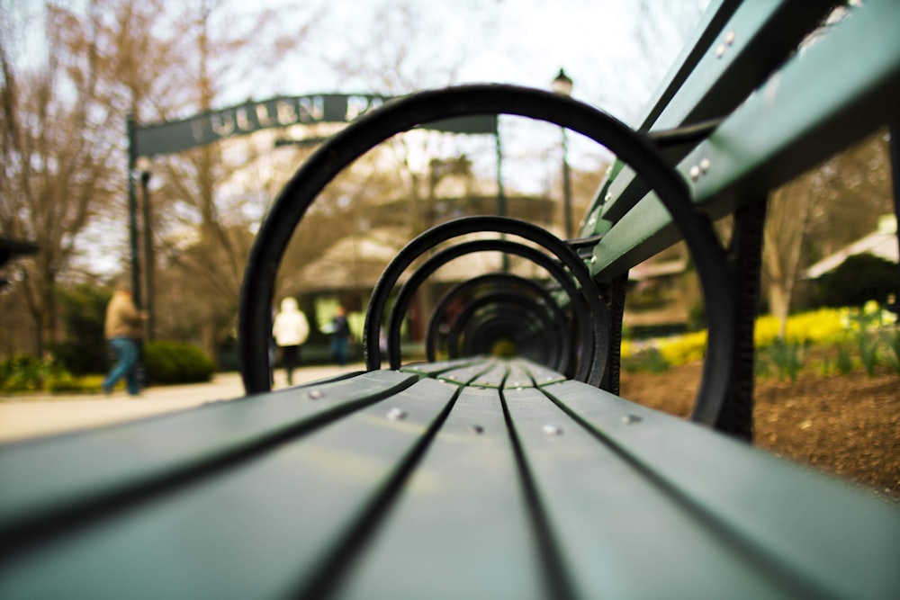 a close up of a park bench in a park