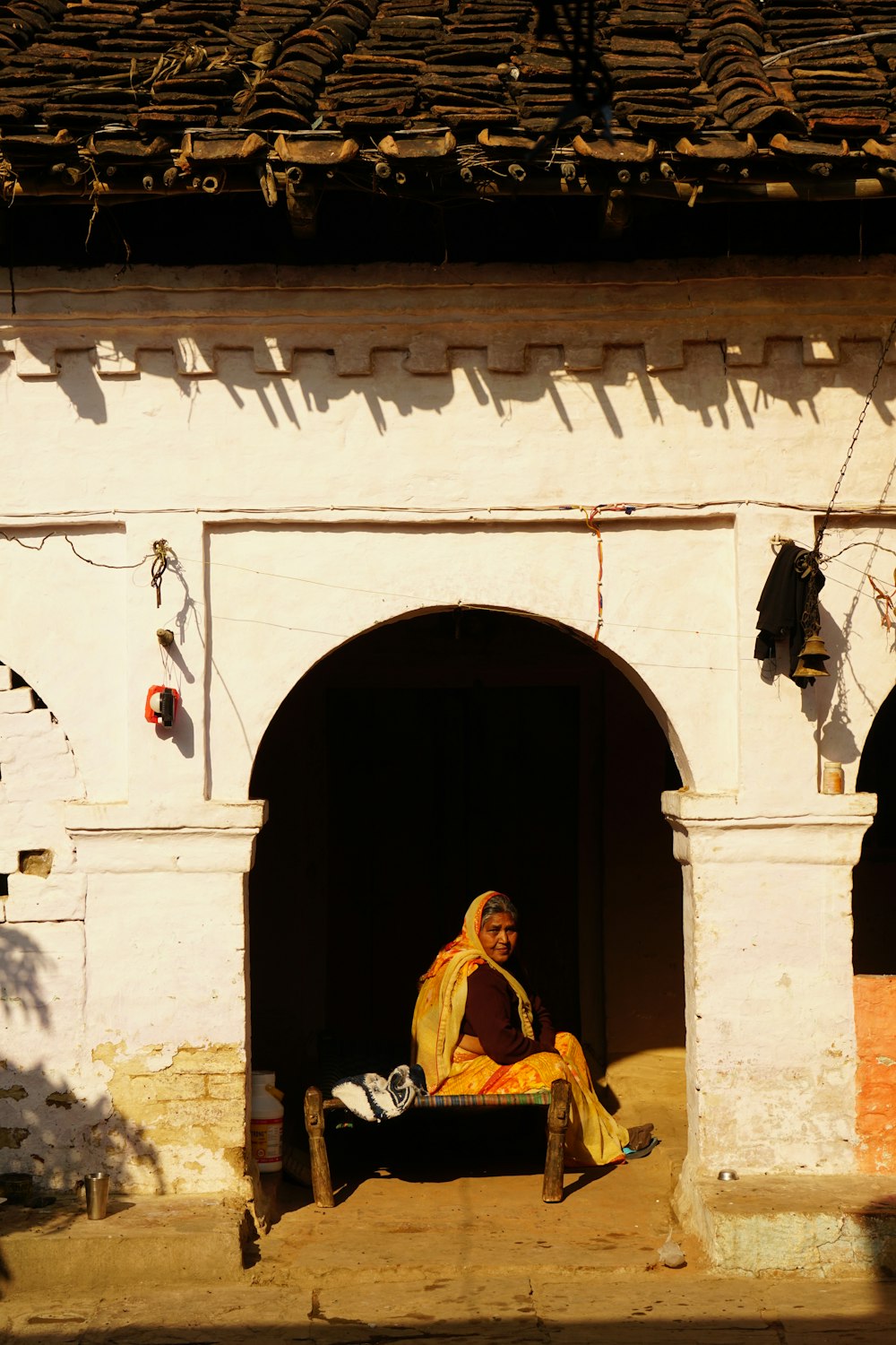 a woman sitting in a doorway of a building