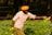 a man in a yellow turban is picking flowers