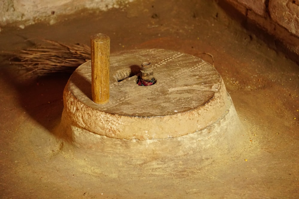 a piece of wood sitting on top of a cement floor