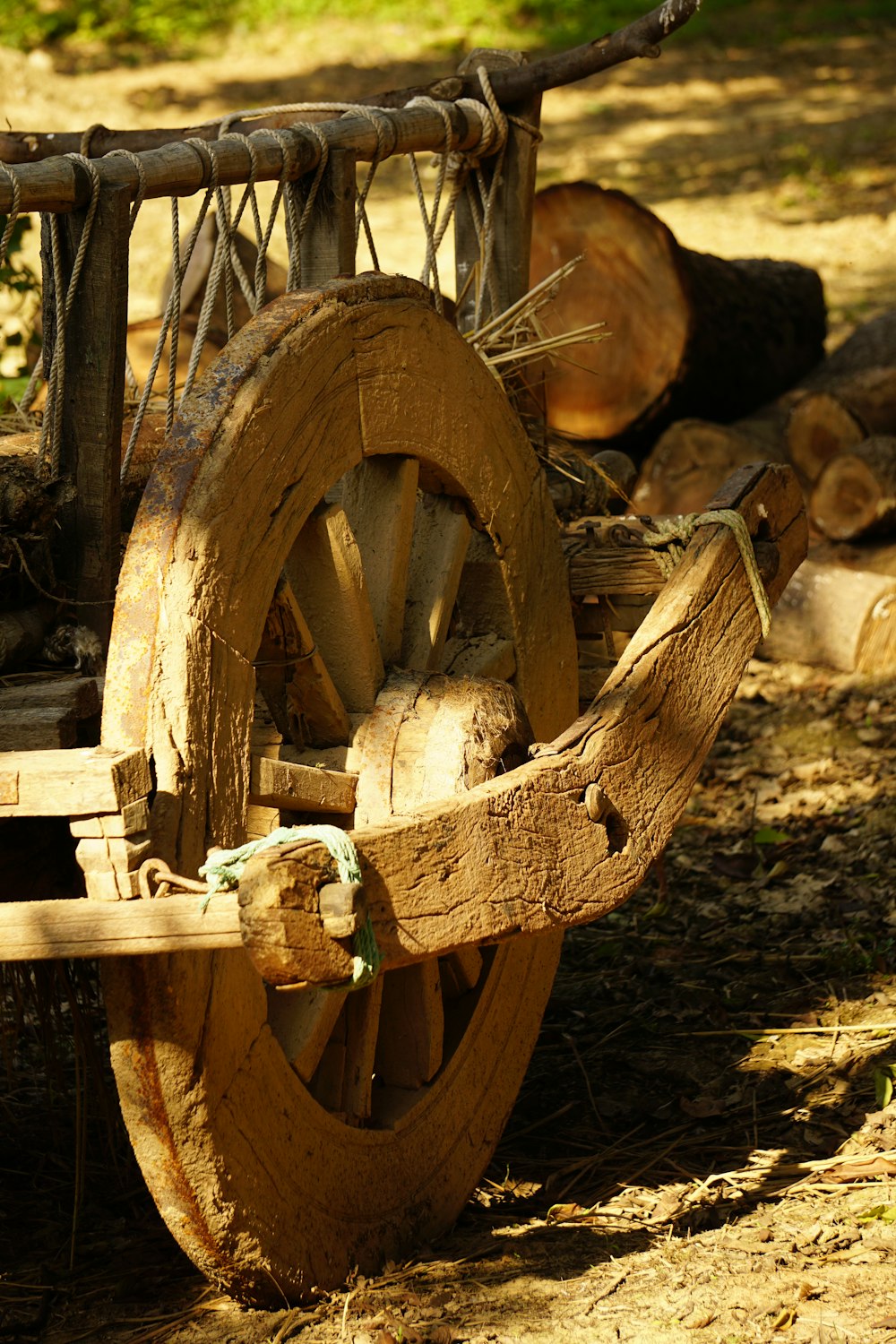 an old wooden wagon with wheels and rope