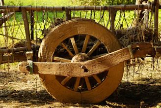 an old wooden wagon with a wooden wheel
