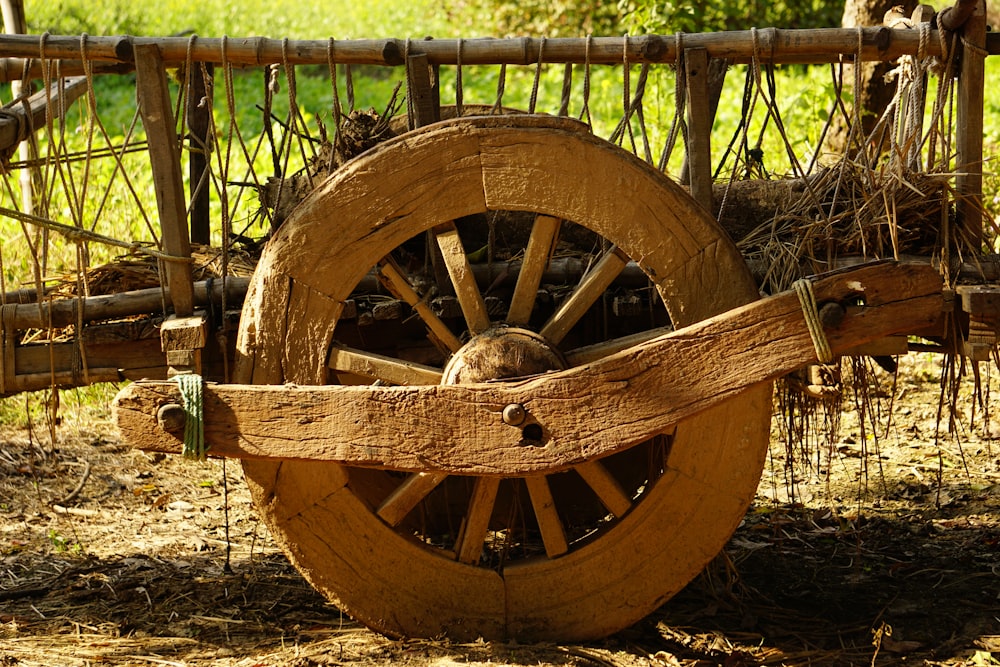 an old wooden wagon with a wooden wheel