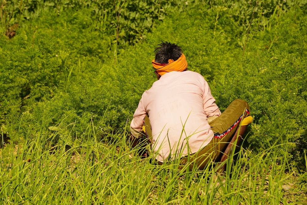 a person sitting in a field of tall grass