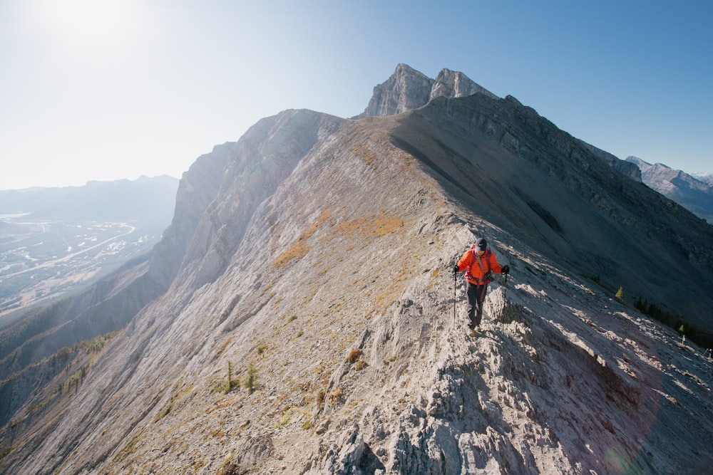 a man climbing up the side of a mountain