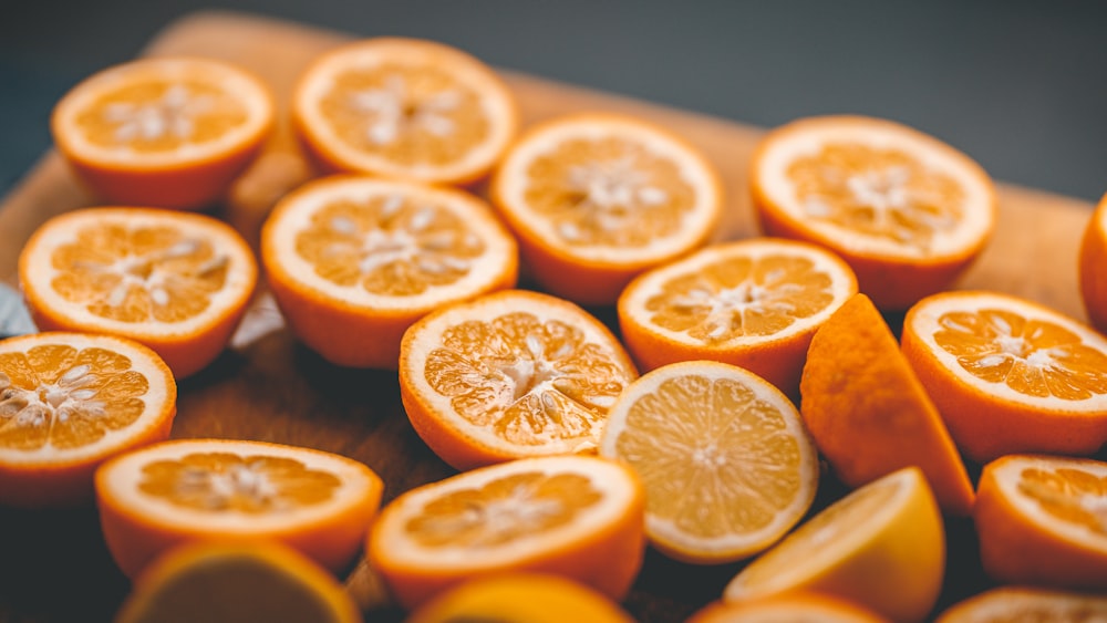 a wooden cutting board topped with sliced oranges