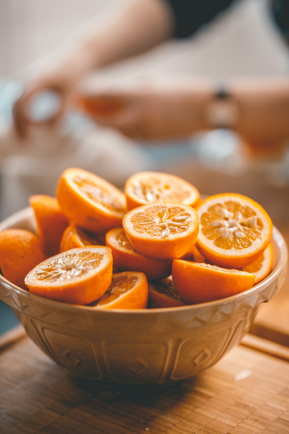 a bowl of oranges sitting on a table
