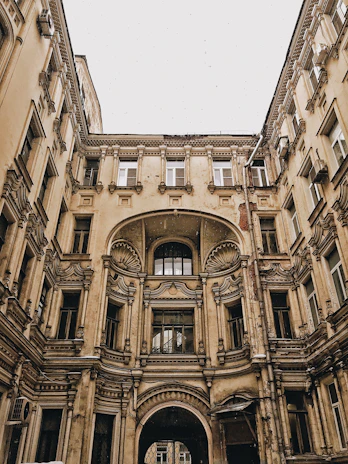 Elegant courtyard paved with reclaimed flagstone, framed by classic European architectural details.