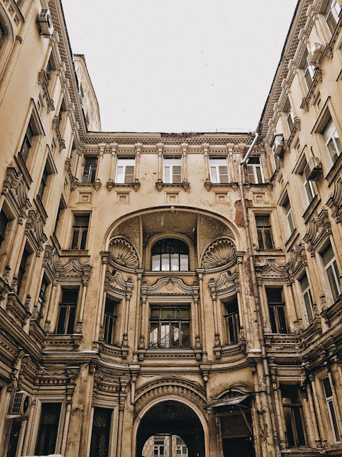 Elegant courtyard paved with centuries-old European flagstone, framed by classic architectural details.