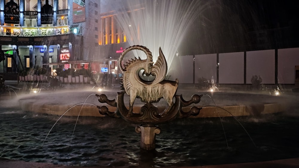 a water fountain with a ram head on it