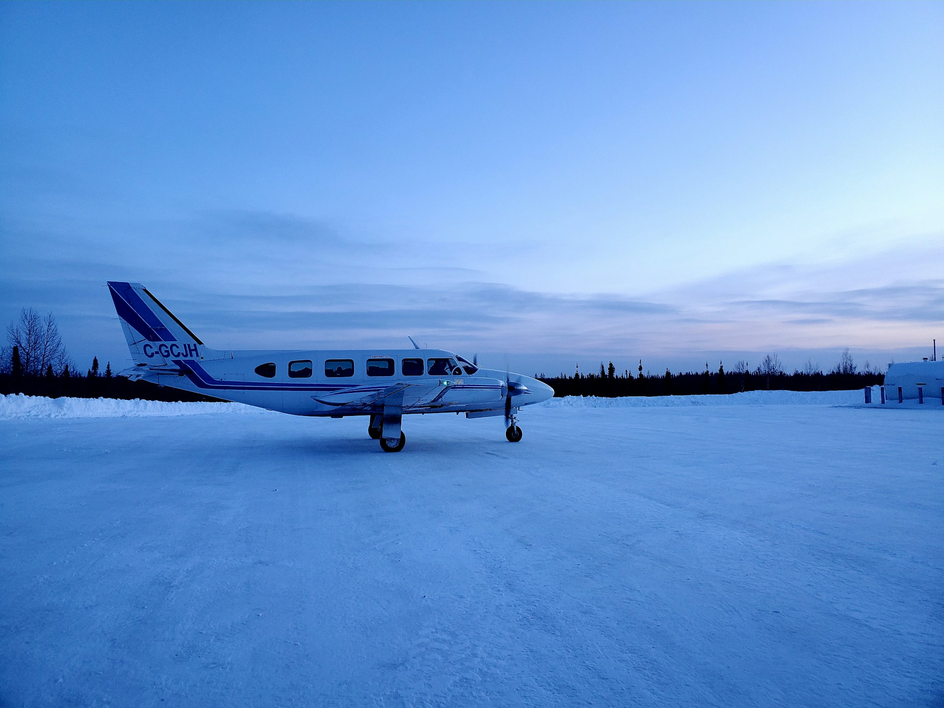 a small airplane sitting on top of a snow covered field