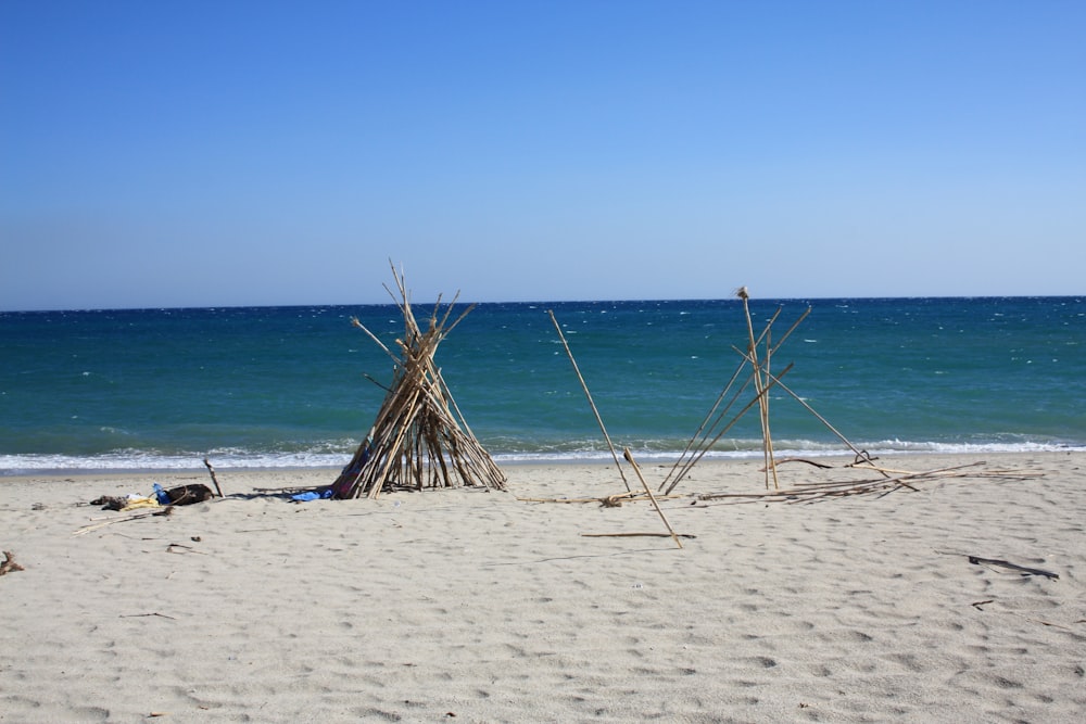 a teepee sitting on top of a sandy beach