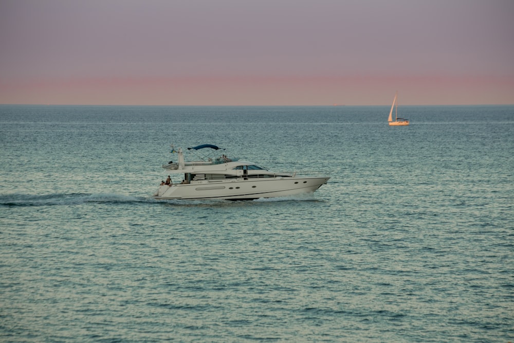 a white boat traveling across a large body of water