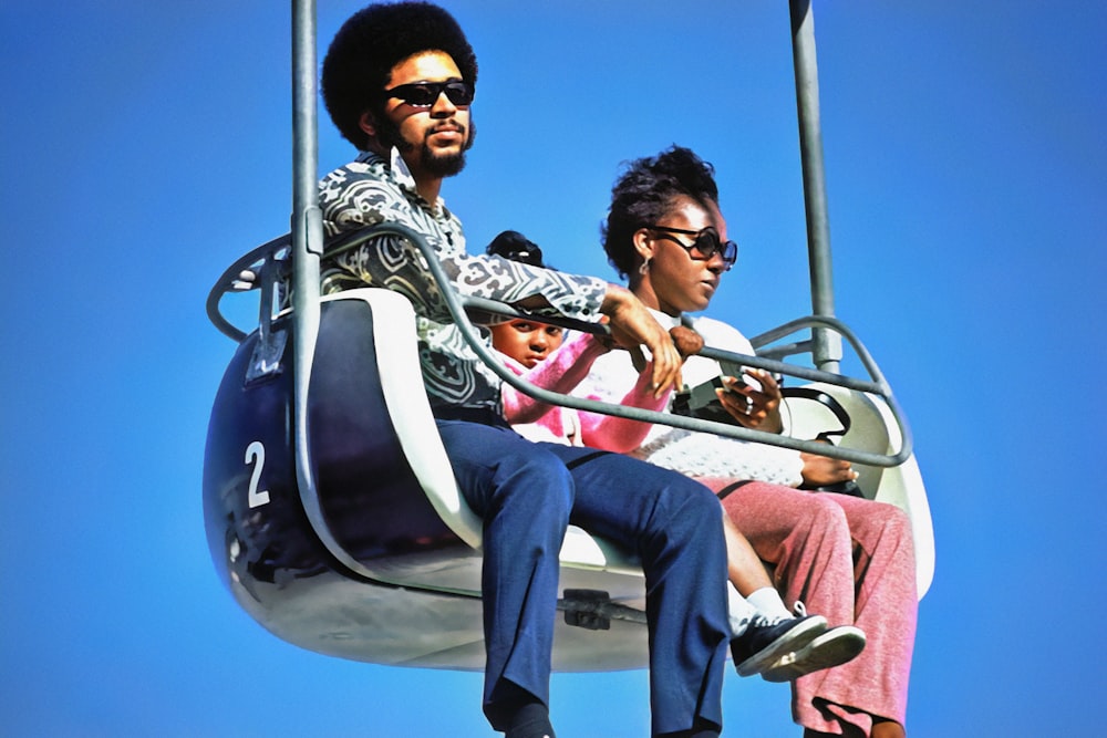 a man and a woman ride on a ferris wheel