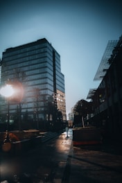a person walking down a street next to a tall building