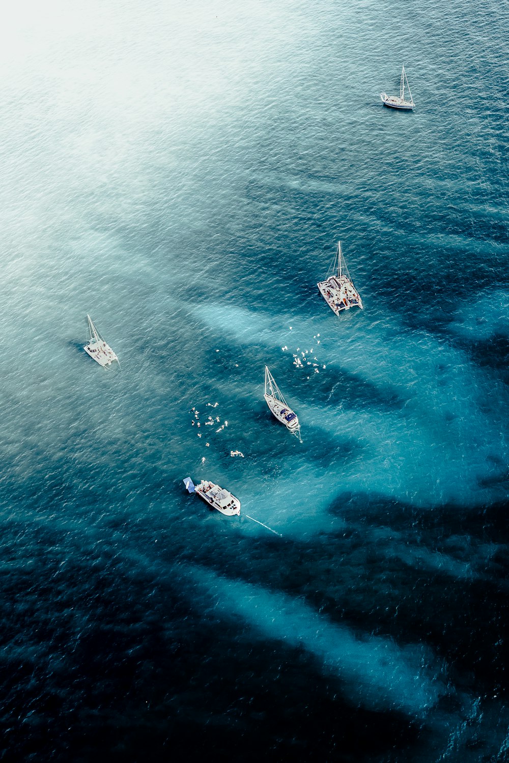 a group of boats floating on top of a large body of water