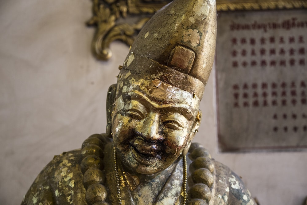 a close up of a statue of a person wearing a hat