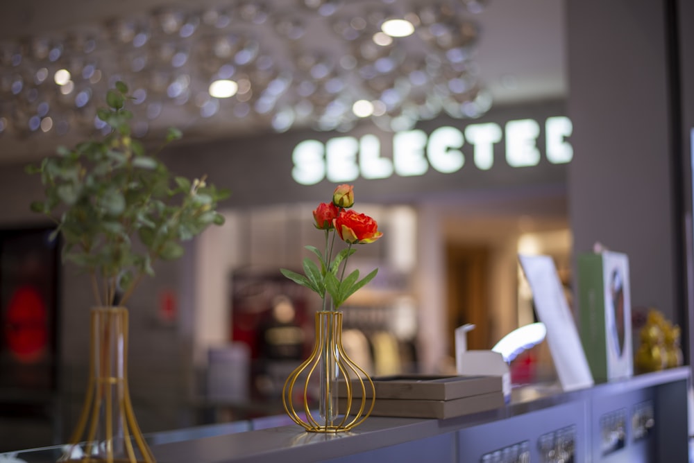 a vase of flowers on a counter in a store