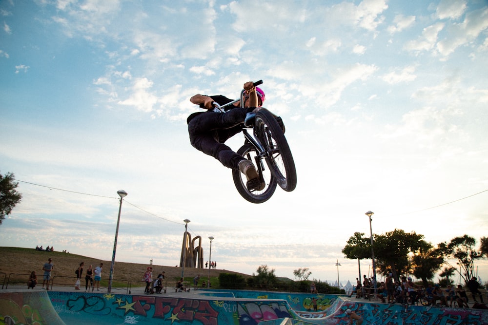 a man flying through the air while riding a bike