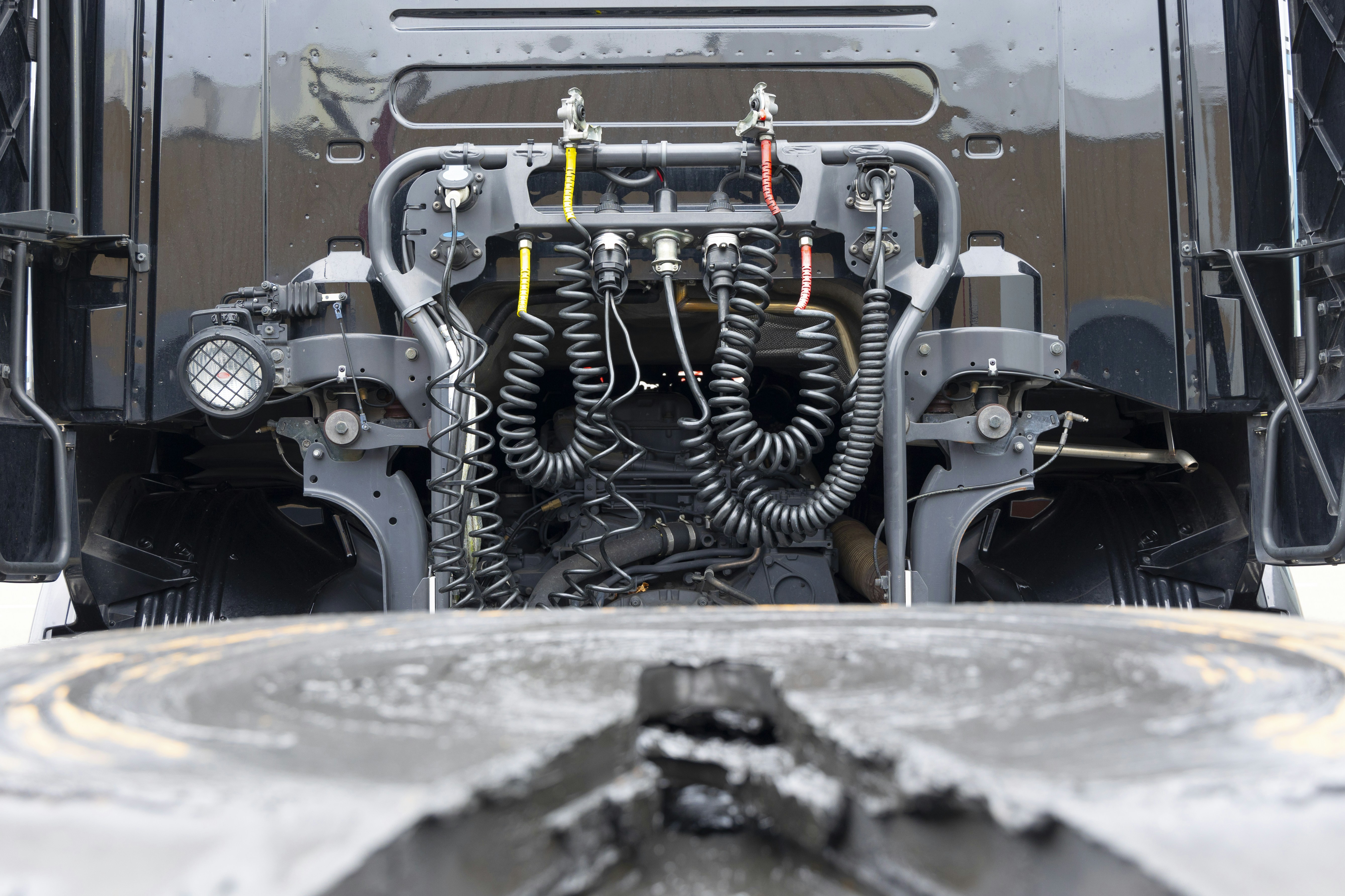 Undercarriage view of an electric car showing dual motors driving front and rear axles