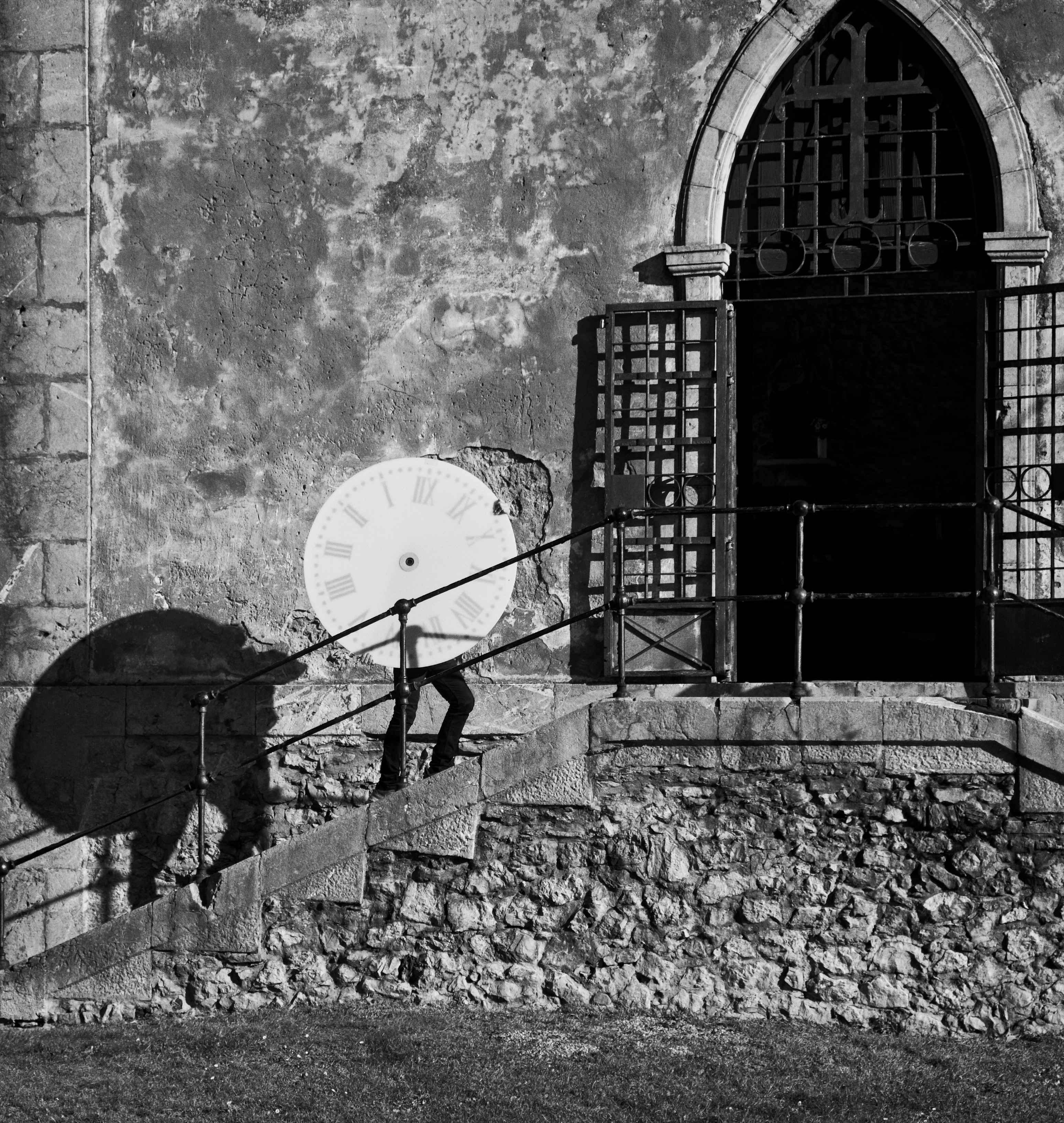 a black and white photo of a person walking up a set of stairs with a
