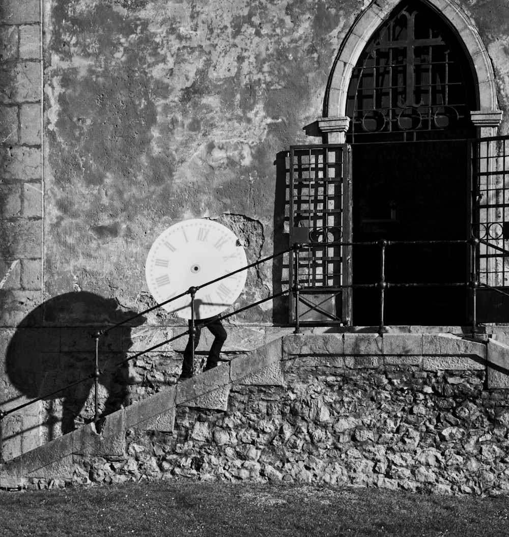 a black and white photo of a person walking up a set of stairs with a