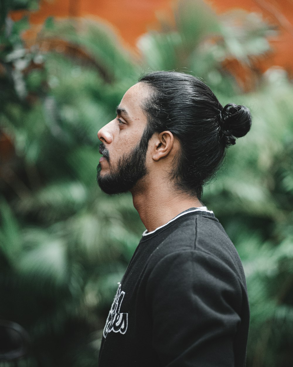 a man with a bun in his hair