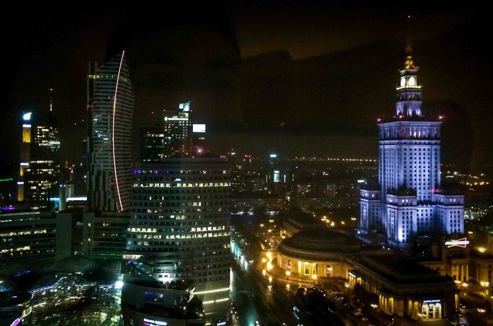 a night view of a city with tall buildings