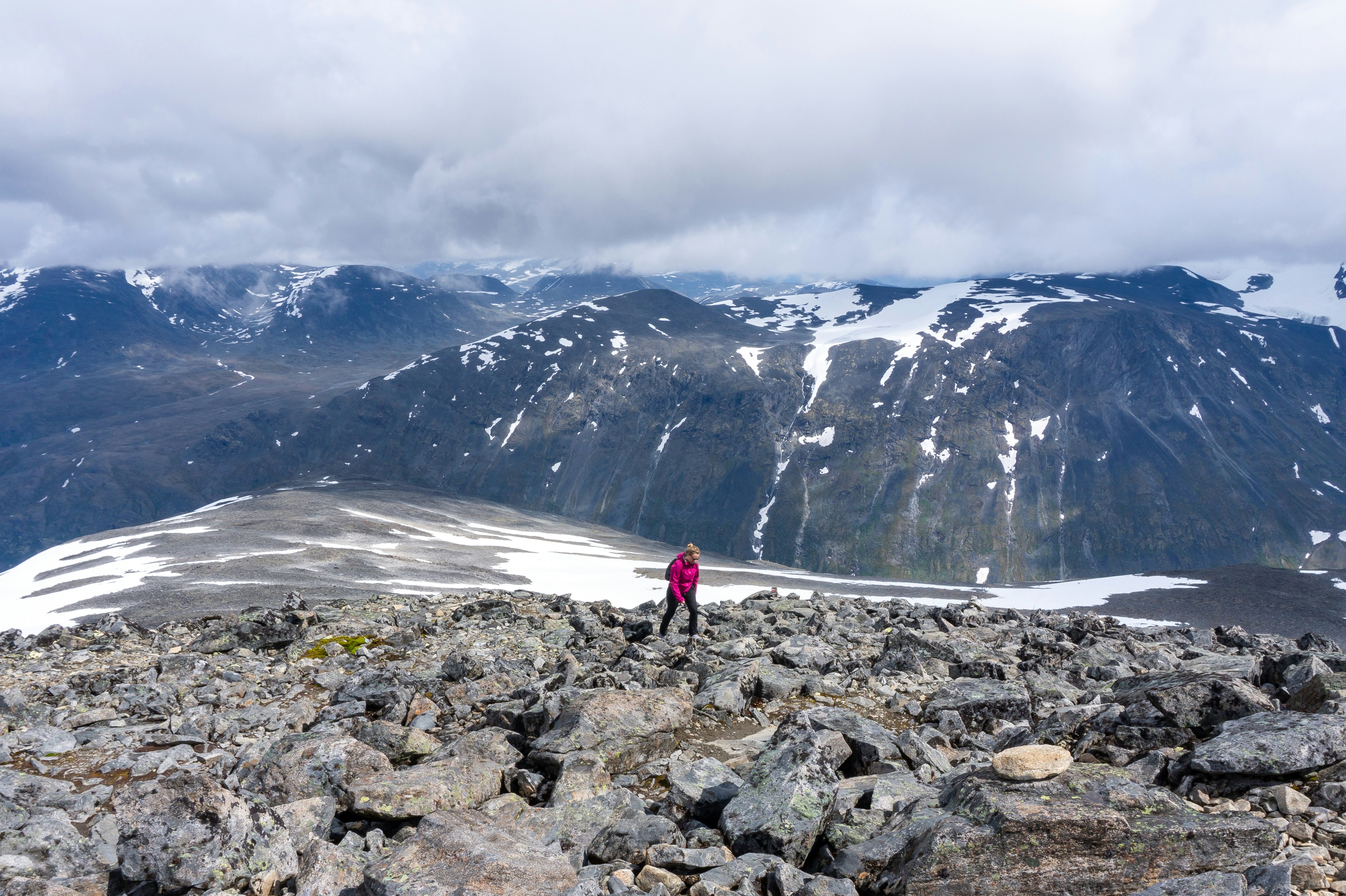 a person standing on top of a rocky mountain